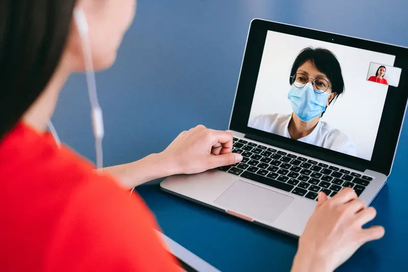 A patient at home on a video call with a doctor