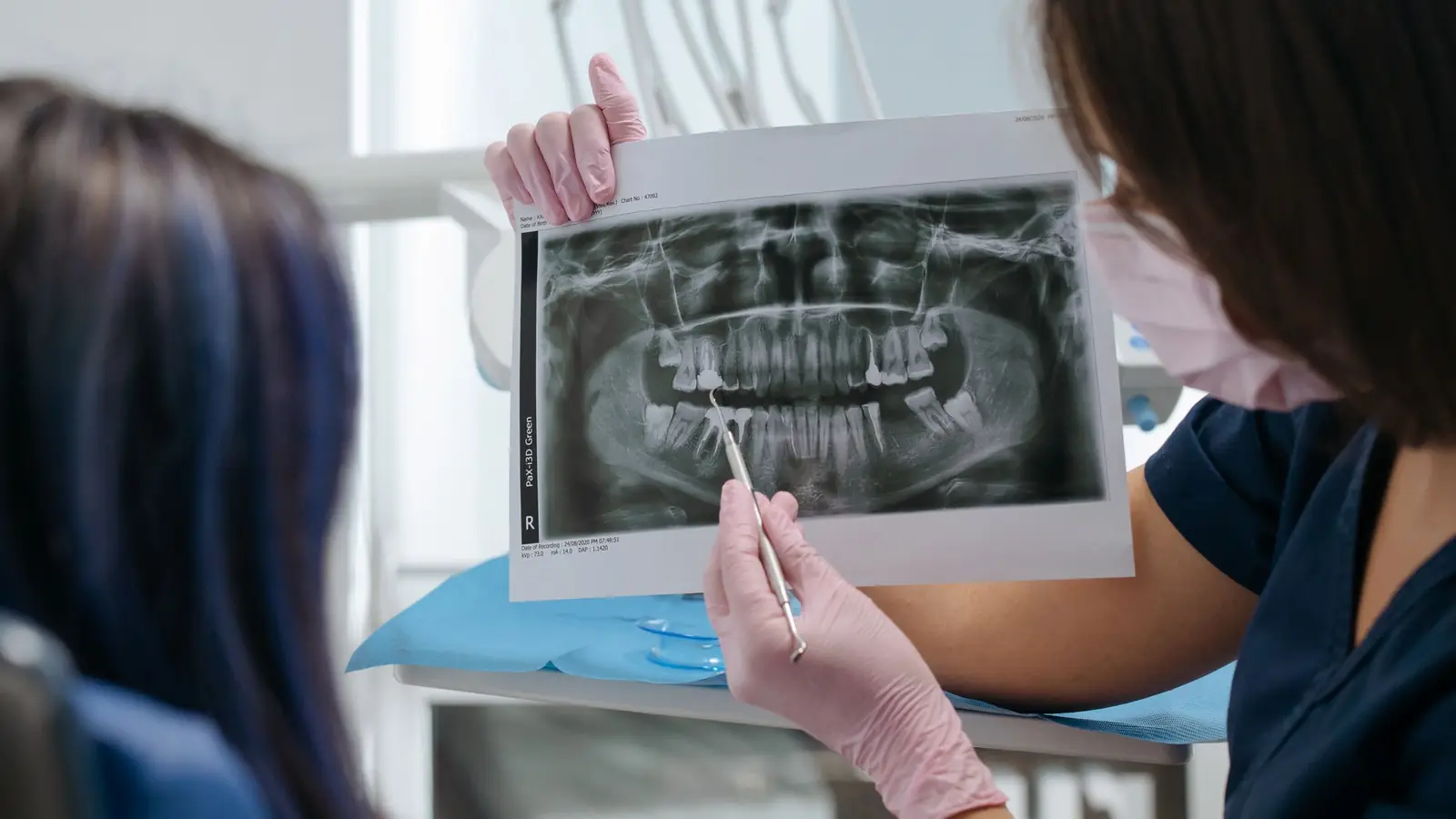 A dentist explaining a panoramic dental X-ray