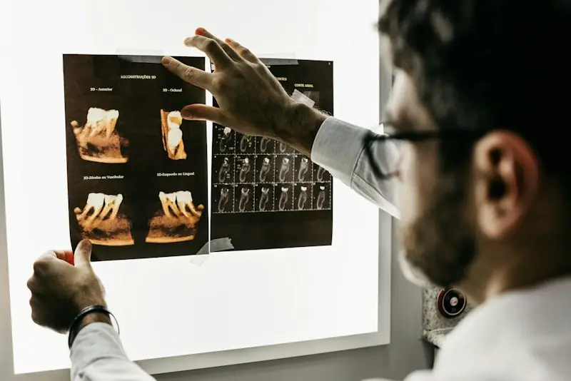 A dentist studying dental X-rays on a light box